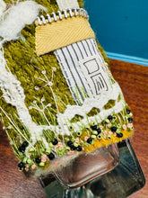 Load image into Gallery viewer, Gwaith ffelt a gwnio wedi ei wneud â llaw a’i lapio am botel wydr / Handmade felt and sewing work wrapped around a glass bottle
