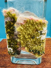 Load image into Gallery viewer, Gwaith ffelt a gwnio wedi ei wneud â llaw a’i lapio am botel wydr / Handmade felt and sewing work wrapped around a glass bottle