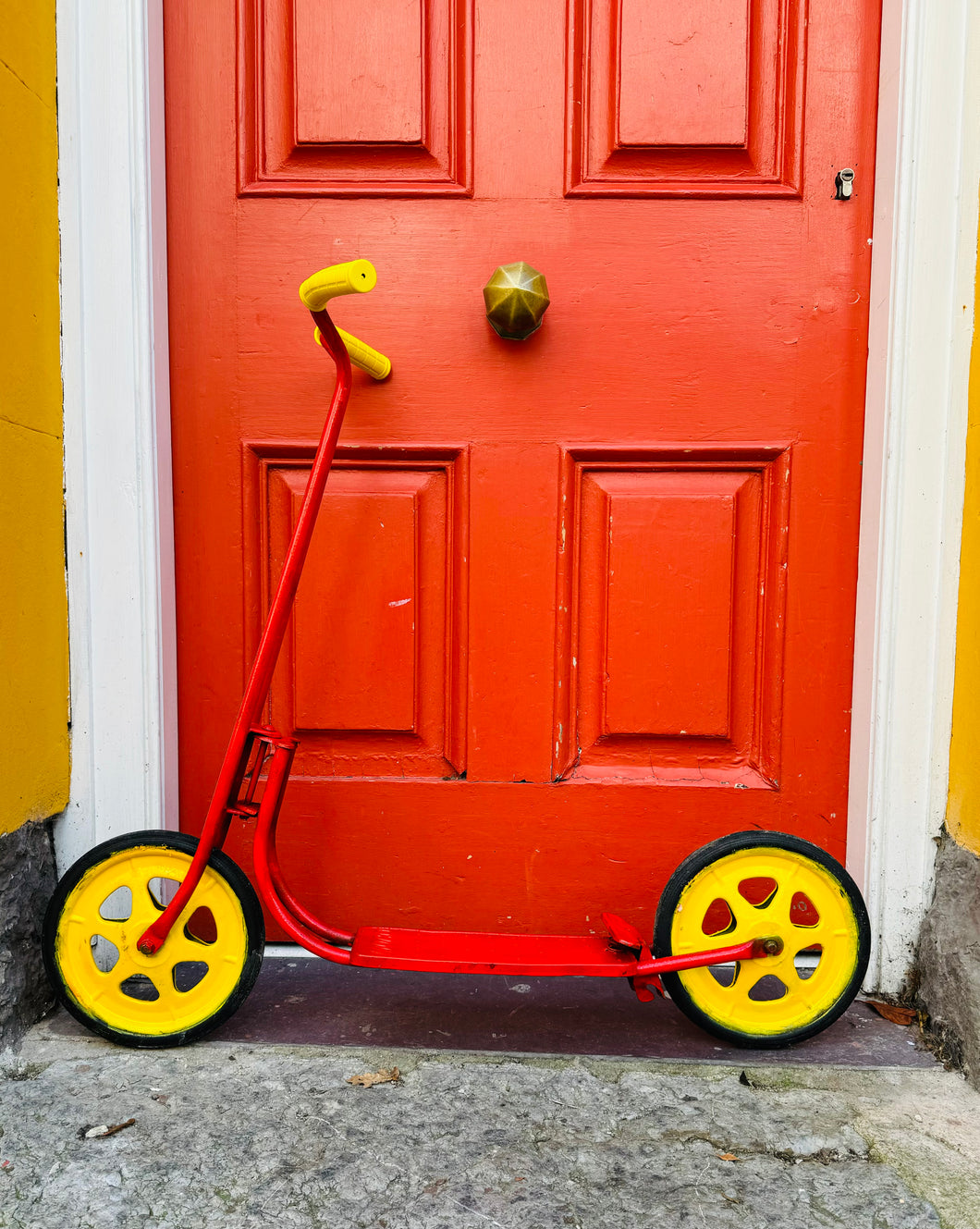 Scŵter plentyn metel coch a melyn Vintage o’r 60au / Vintage red and yellow metal child’s scooter from the 60s